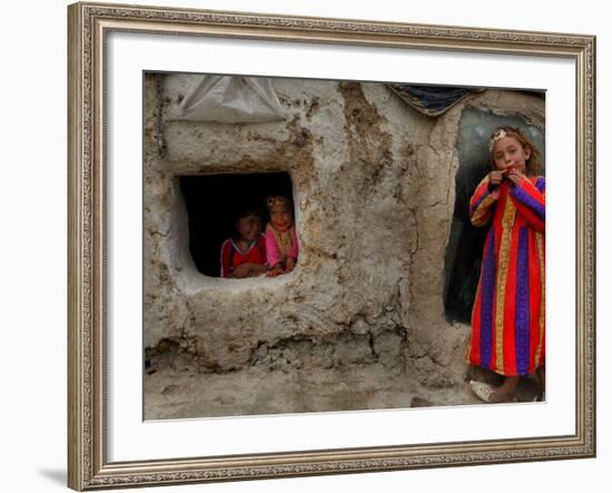 Displaced Girls Smile as They Look Out from a Shanty, in a Refugee Camp in Kabul, Afghanistan-null-Framed Photographic Print