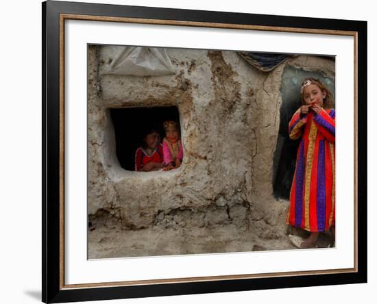 Displaced Girls Smile as They Look Out from a Shanty, in a Refugee Camp in Kabul, Afghanistan-null-Framed Photographic Print