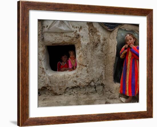 Displaced Girls Smile as They Look Out from a Shanty, in a Refugee Camp in Kabul, Afghanistan-null-Framed Photographic Print