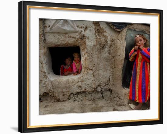 Displaced Girls Smile as They Look Out from a Shanty, in a Refugee Camp in Kabul, Afghanistan-null-Framed Photographic Print