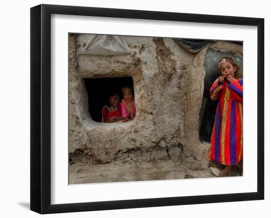 Displaced Girls Smile as They Look Out from a Shanty, in a Refugee Camp in Kabul, Afghanistan-null-Framed Photographic Print