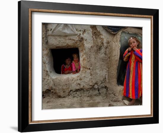 Displaced Girls Smile as They Look Out from a Shanty, in a Refugee Camp in Kabul, Afghanistan-null-Framed Photographic Print