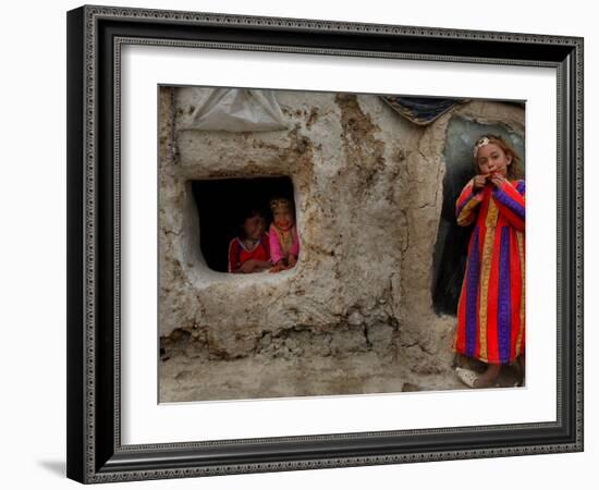 Displaced Girls Smile as They Look Out from a Shanty, in a Refugee Camp in Kabul, Afghanistan-null-Framed Photographic Print