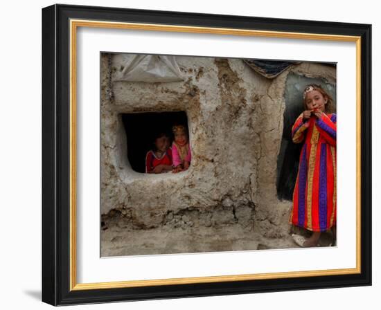 Displaced Girls Smile as They Look Out from a Shanty, in a Refugee Camp in Kabul, Afghanistan-null-Framed Photographic Print