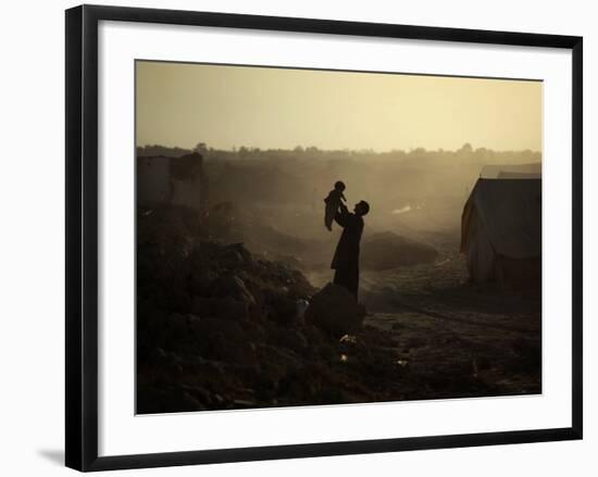 Displaced Man Holds His Baby Next to His Tent in Jalozai Refugee Camp Near Peshawar, Pakistan-null-Framed Photographic Print