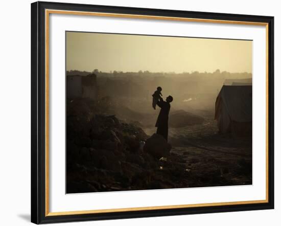 Displaced Man Holds His Baby Next to His Tent in Jalozai Refugee Camp Near Peshawar, Pakistan-null-Framed Photographic Print