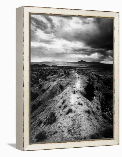 Distant of Artist Georgia O'Keeffe Taking Her Evening Walk at Ghost Ranch-John Loengard-Framed Premier Image Canvas