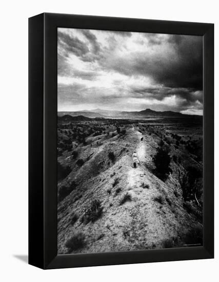 Distant of Artist Georgia O'Keeffe Taking Her Evening Walk at Ghost Ranch-John Loengard-Framed Premier Image Canvas