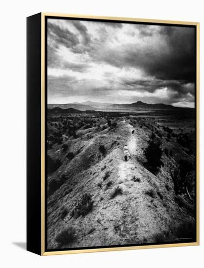 Distant of Artist Georgia O'Keeffe Taking Her Evening Walk at Ghost Ranch-John Loengard-Framed Premier Image Canvas