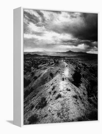 Distant of Artist Georgia O'Keeffe Taking Her Evening Walk at Ghost Ranch-John Loengard-Framed Premier Image Canvas