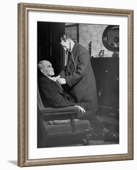 Doctor Making a House Call to an Ill Elderly Man, Listening to the Rhythm of His Heart-null-Framed Photographic Print