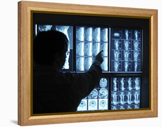 Doctor Pointing to X-Ray Images on Computer Screen-null-Framed Premier Image Canvas