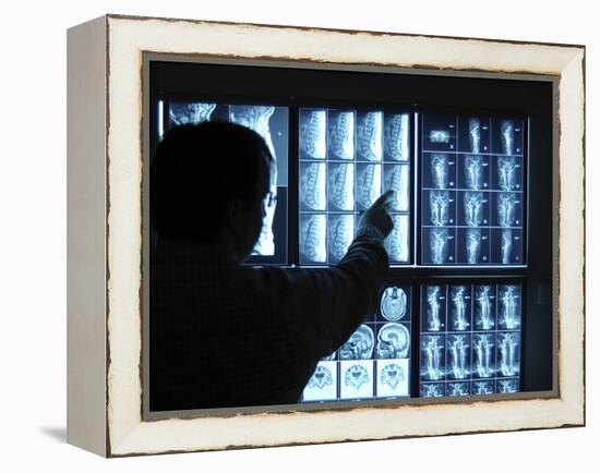 Doctor Pointing to X-Ray Images on Computer Screen-null-Framed Premier Image Canvas