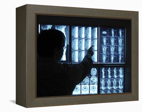 Doctor Pointing to X-Ray Images on Computer Screen-null-Framed Premier Image Canvas