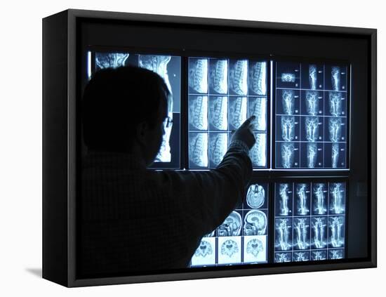 Doctor Pointing to X-Ray Images on Computer Screen-null-Framed Premier Image Canvas