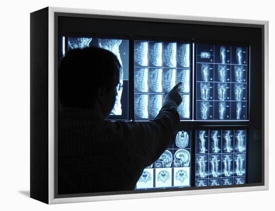 Doctor Pointing to X-Ray Images on Computer Screen-null-Framed Premier Image Canvas