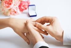 Picture of Man Putting Wedding Ring on Woman Hand-dolgachov-Laminated Photographic Print