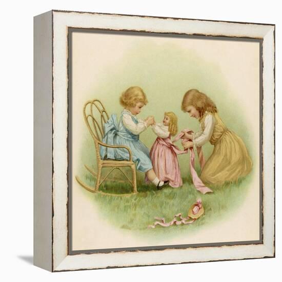 Doll is Dressed by Two Girls One in Front of Her While the Other Ties Her Sash Behind-Ida Waugh-Framed Premier Image Canvas