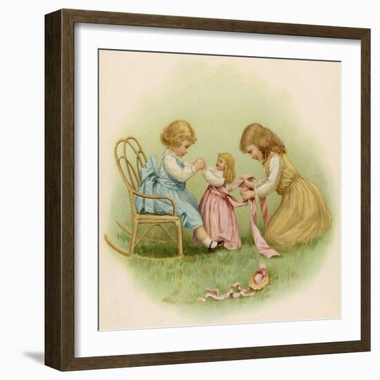 Doll is Dressed by Two Girls One in Front of Her While the Other Ties Her Sash Behind-Ida Waugh-Framed Photographic Print