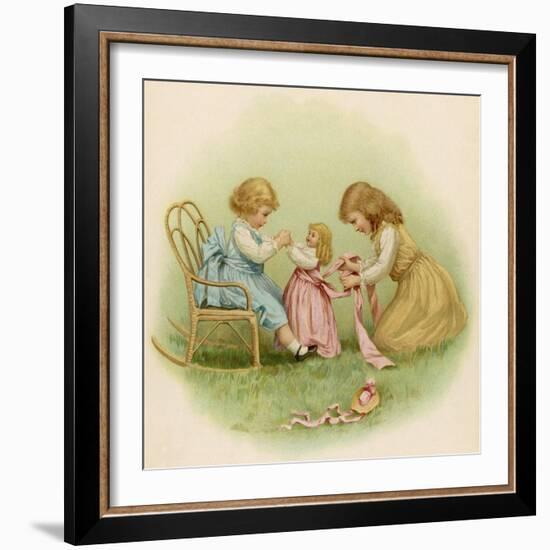 Doll is Dressed by Two Girls One in Front of Her While the Other Ties Her Sash Behind-Ida Waugh-Framed Photographic Print