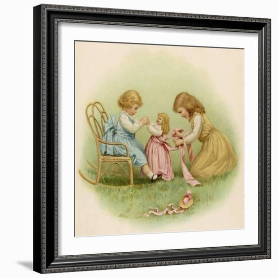 Doll is Dressed by Two Girls One in Front of Her While the Other Ties Her Sash Behind-Ida Waugh-Framed Photographic Print