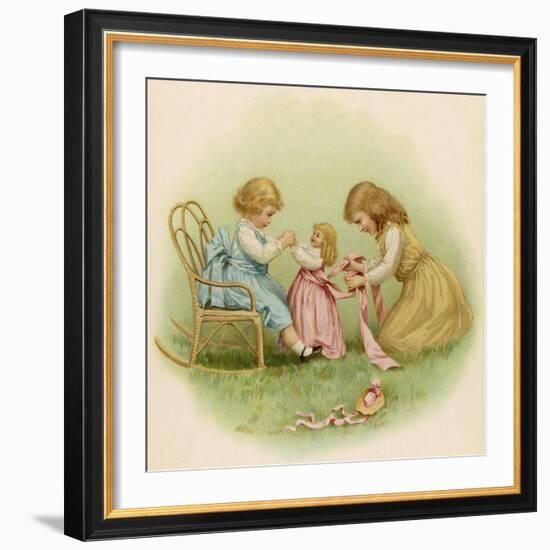 Doll is Dressed by Two Girls One in Front of Her While the Other Ties Her Sash Behind-Ida Waugh-Framed Photographic Print