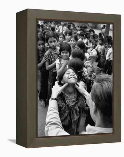 Dr. Nevin S. Scrimshaw of the Central American Institute of Nutrition Examining Children for Goiter-Cornell Capa-Framed Premier Image Canvas