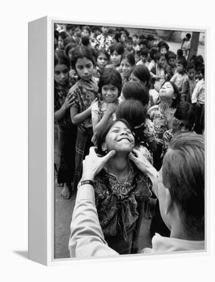 Dr. Nevin S. Scrimshaw of the Central American Institute of Nutrition Examining Children for Goiter-Cornell Capa-Framed Premier Image Canvas