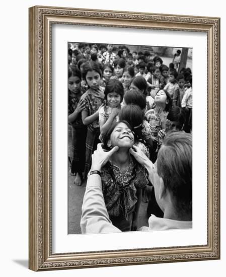 Dr. Nevin S. Scrimshaw of the Central American Institute of Nutrition Examining Children for Goiter-Cornell Capa-Framed Photographic Print