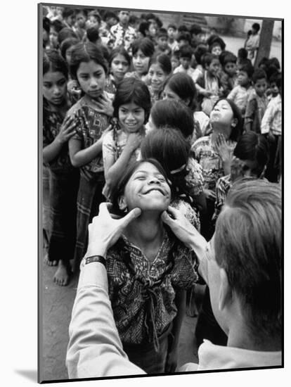 Dr. Nevin S. Scrimshaw of the Central American Institute of Nutrition Examining Children for Goiter-Cornell Capa-Mounted Photographic Print