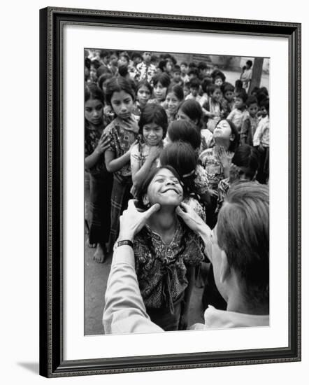 Dr. Nevin S. Scrimshaw of the Central American Institute of Nutrition Examining Children for Goiter-Cornell Capa-Framed Photographic Print