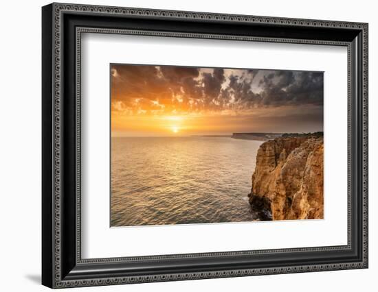 Dramatic sunset clouds over Cliffs along the coast at Ponta da Piedade in Lagos, Portugal-Chuck Haney-Framed Photographic Print