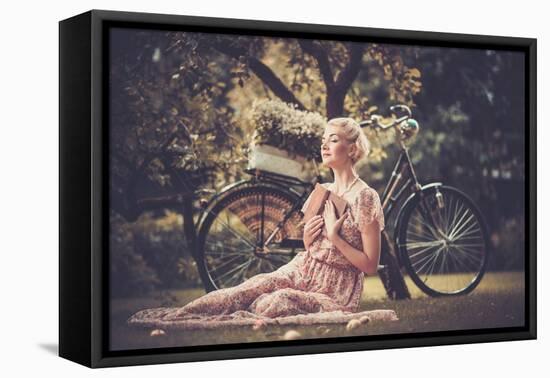 Dreaming Blond Retro Woman with a Book Sitting on a Meadow-NejroN Photo-Framed Premier Image Canvas