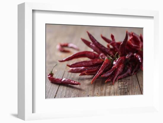 Dried Chillipods on Wooden Table-Jana Ihle-Framed Photographic Print