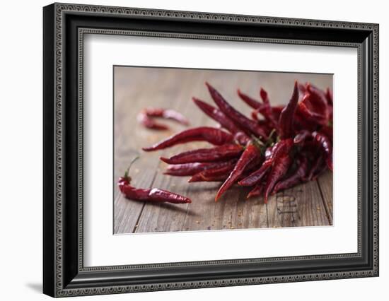 Dried Chillipods on Wooden Table-Jana Ihle-Framed Photographic Print