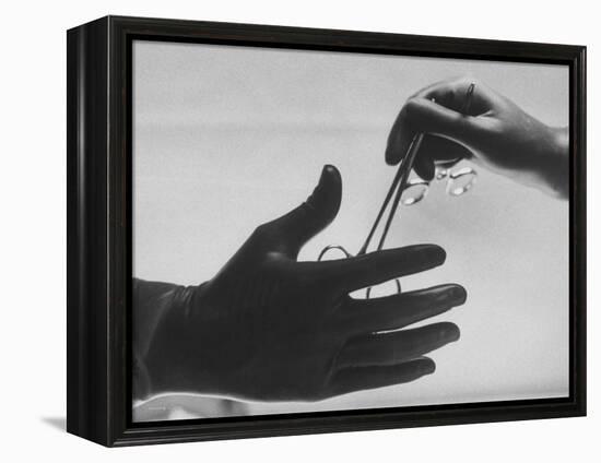 During Training of Surgeon, Often Used Clamp Is Slapped into His Hand-Ed Clark-Framed Premier Image Canvas