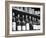 Dust-Covered Wine and Brandy Bottles Standing on Racks in a Wine Cellar-null-Framed Photographic Print