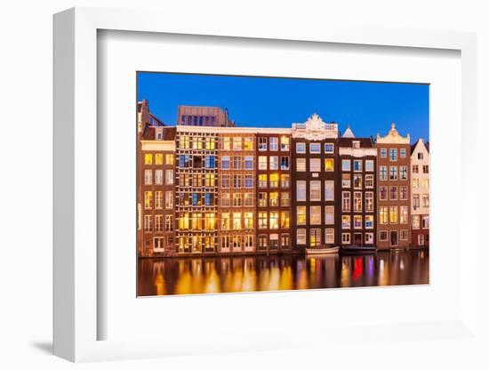 Dutch gables on row of typical Amsterdam houses at night with reflections in the Damrak canal-Neale Clark-Framed Photographic Print