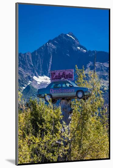 Eads Auto, Seward Alaska - a car in the trees under a large mountain-null-Mounted Photographic Print