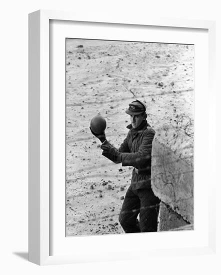 East German Border Guard Tossing Ball over Berlin Wall after German boy accidently threw it over-Paul Schutzer-Framed Photographic Print