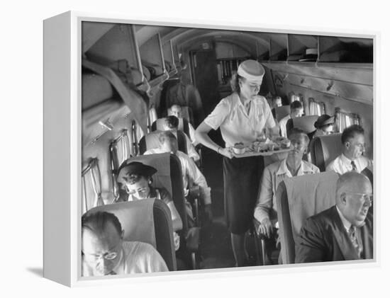 Eastern Airline Travelers Receiving a Mid-Flight Meal from a Female Steward-null-Framed Premier Image Canvas