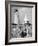 Eddie Frank Preparing to Eat Lunch on Rocks Next to His Dog in Front of Lighthouse-Alfred Eisenstaedt-Framed Photographic Print