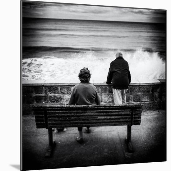 Elderly Couple Watch the Waves-Rory Garforth-Mounted Photographic Print