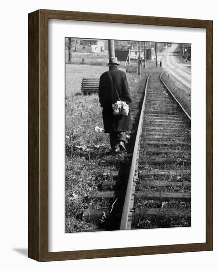 Elderly Hobo, with Bundle Strapped to His Back, Walking Along Train Tracks-Carl Mydans-Framed Photographic Print