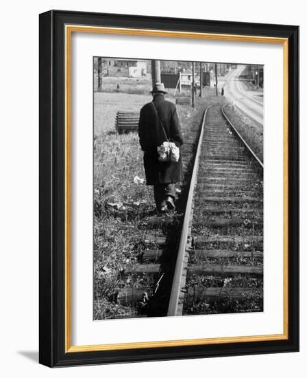 Elderly Hobo, with Bundle Strapped to His Back, Walking Along Train Tracks-Carl Mydans-Framed Photographic Print