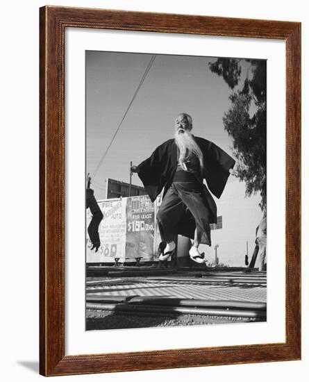 Elderly Japanese Movie Extra Jumping on Trampoline-Ralph Crane-Framed Photographic Print