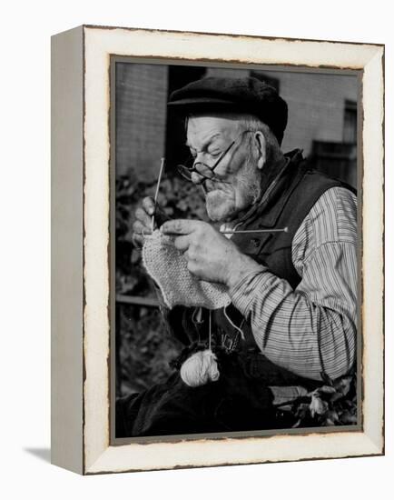 Elderly Man Knitting Garments During Drive to Provide Goods to Servicemen During the War-null-Framed Premier Image Canvas