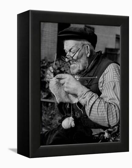 Elderly Man Knitting Garments During Drive to Provide Goods to Servicemen During the War-null-Framed Premier Image Canvas