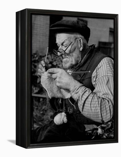 Elderly Man Knitting Garments During Drive to Provide Goods to Servicemen During the War-null-Framed Premier Image Canvas