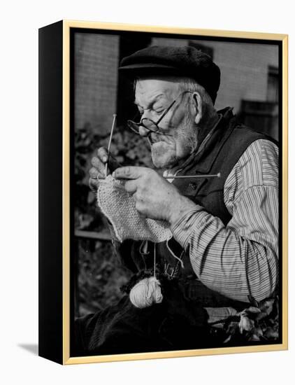 Elderly Man Knitting Garments During Drive to Provide Goods to Servicemen During the War-null-Framed Premier Image Canvas